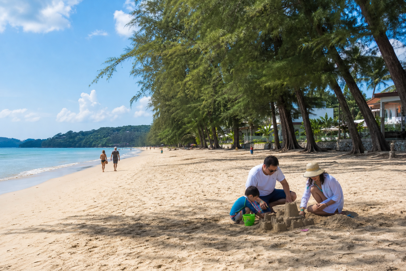 Family builds a sandcastle under trees at a relaxed generic Phuket beach